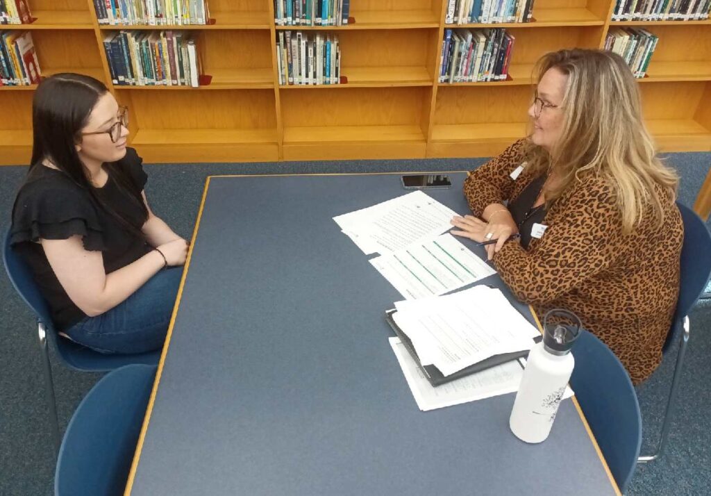 A local business professional interview a Crothersville High School senior during Mock Interview Day.